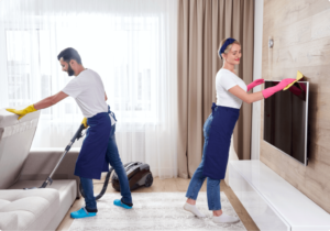 professional cleaners blue uniform washing floor wiping dust from furniture living room apartment cleaning service concept 1 1024x717 1 300x210 1
